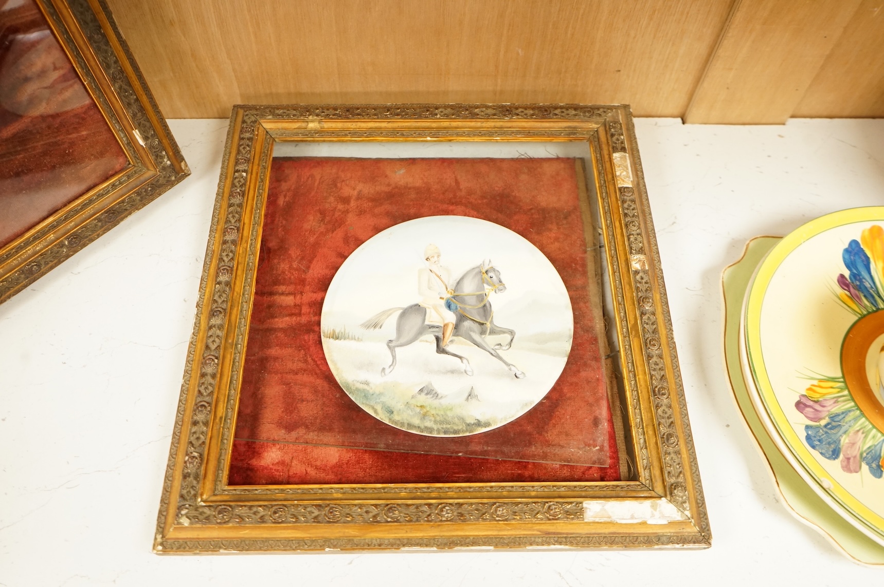 A pair of naive watercolours on circular porcelain panels, soldiers on horseback, framed, 15cm in diameter